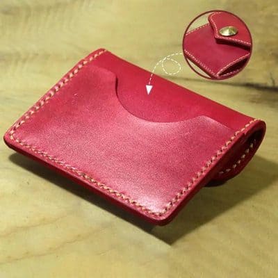 Red leather cardholder with secure snap closure, perfect for organizing cash and cards, featured at Monalisa Medical store. Made with durable, high-quality materials, ideal for daily use.