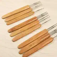 Ultrasound probe cleaning tools with wooden handles and metal tips for precise ultrasound instrument maintenance.