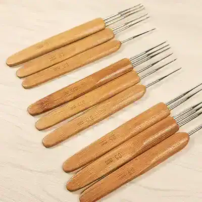 Ultrasound probe cleaning tools with wooden handles and metal tips for precise ultrasound instrument maintenance.