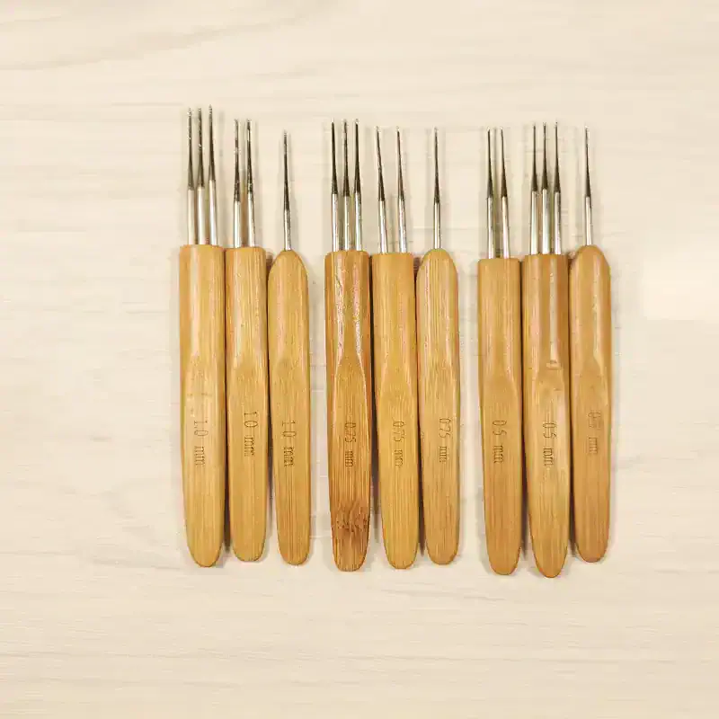 Tweezer set with wooden handles used for precise eyeglass repair and lens handling.