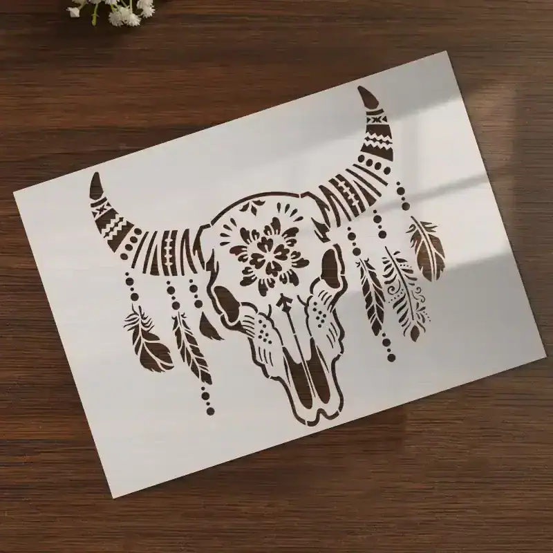 Intricate black and white buffalo skull with feather and floral designs, art stencil for wall decor, ideal for bohemian or eclectic interior styles.