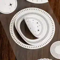 Delicate black and white starry sky designs on circular cutouts for skincare or beauty product packaging at Monalisa Store.