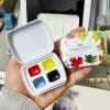 Bright watercolor paint set with red, yellow, blue, and black colors in compact case for arts and crafts.