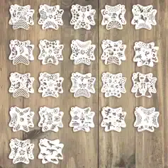 Delicate white paper snowflake cutouts with intricate holiday and winter-themed designs, perfect for Christmas decorations, arts and crafts, and festive home decor.