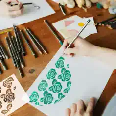 Vase-shaped stencil with roses for wall decor or crafting, created using marker pens and art supplies at a creative workshop.