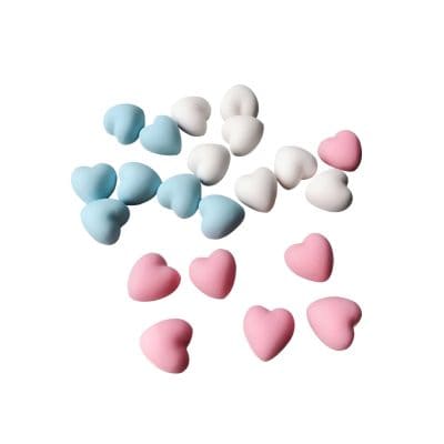 Colorful heart-shaped candies in pastel pink, blue, white, and gray, arranged on a white background, representing healthcare, wellness, and optometry store products from Monalisa Store.