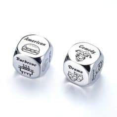 Shiny silver dice with engraved labels and icons representing American cuisine, comedy, drama, and barbecue, ideal for food and entertainment enthusiasts looking for unique themed accessories.