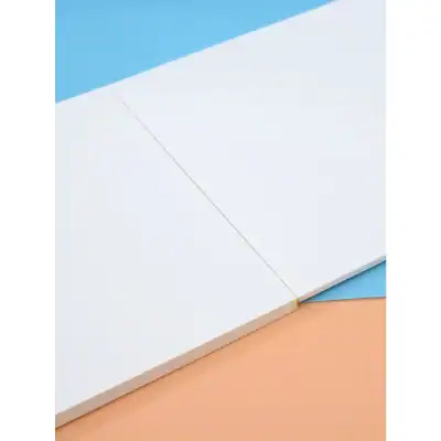 White dermatology or skincare product packaging with pastel blue and orange background, emphasizing clean, minimal design ideal for skincare and aesthetics branding.