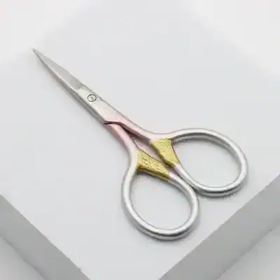 Sterile surgical scissors with gold accents, ideal for precision medical procedures in optometry and ophthalmology clinics.
