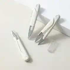 Precision surgical scalpels with white ergonomic handles, sterilized for safe medical procedures and dermatological treatments, displayed on a clean white surface.