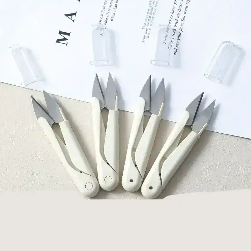 Stainless steel manicure and pedicure cuticle nippers with ergonomic white handles, ideal for precision nail care and cuticle trimming. Suitable for professional and home use.