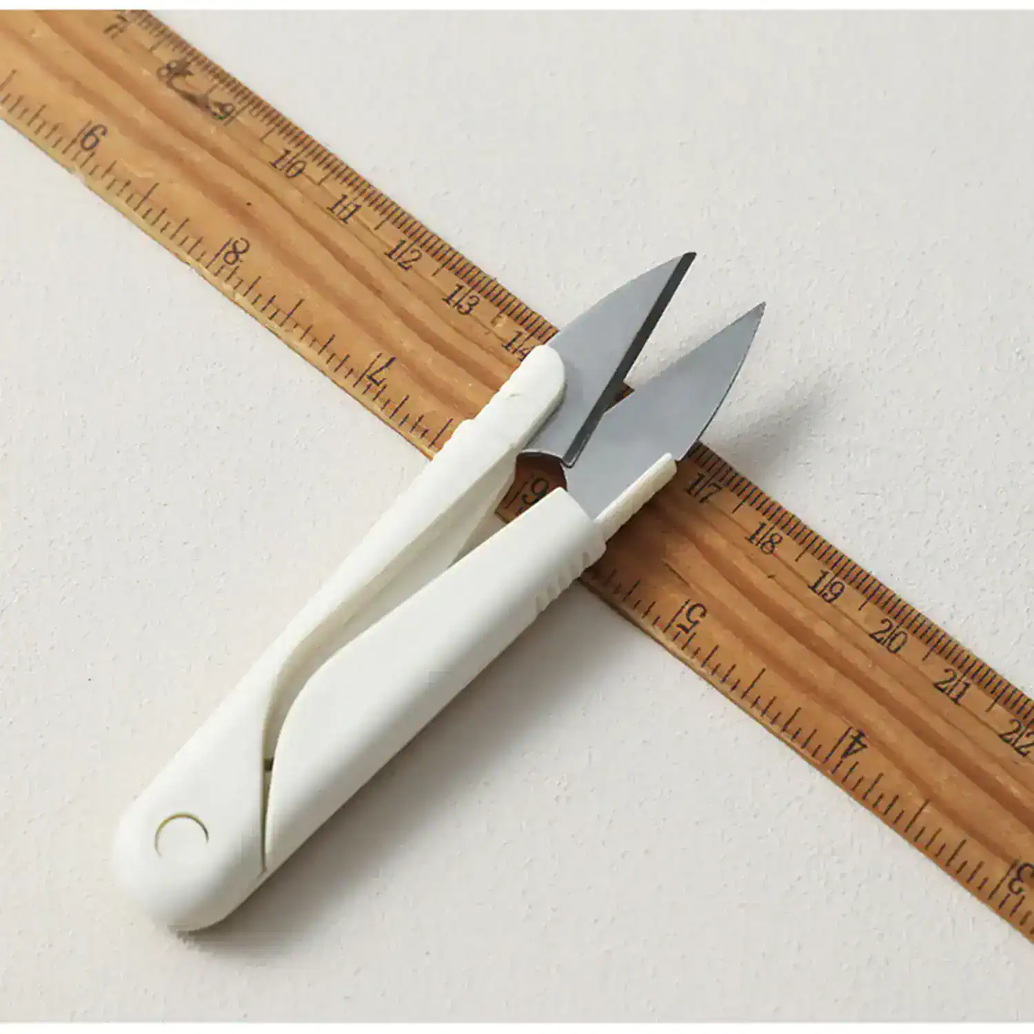 Precision surgical scalpel with white handle and stainless steel blades, ideal for delicate medical procedures and eye care treatments.