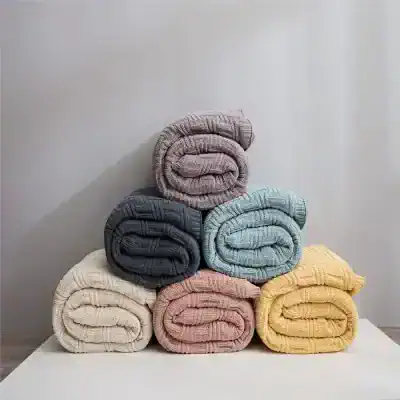Colorful folded cozy blankets stacked neatly, perfect for home decor, comfort, and warmth. Available in pastel and neutral shades, ideal for living rooms, bedrooms, or gifting, at Monalisa Medical Store.