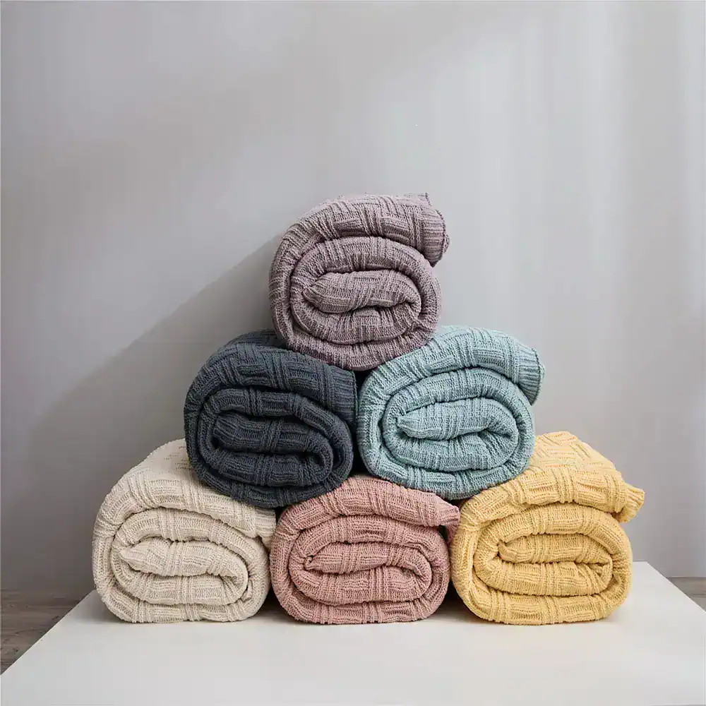 Colorful folded cozy blankets stacked neatly, perfect for home decor, comfort, and warmth. Available in pastel and neutral shades, ideal for living rooms, bedrooms, or gifting, at Monalisa Medical Store.