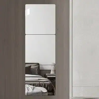 Modern bedroom with minimalist decor, neutral color palette, and stylish furniture including a bed with black and white bedding, a bedside table, and an elegant vase.