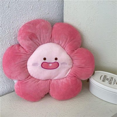 Soft pink flower-shaped plush pillow with a cute smiling face, ideal for children's bedrooms or gifts, available at Monalisa Medical Store.