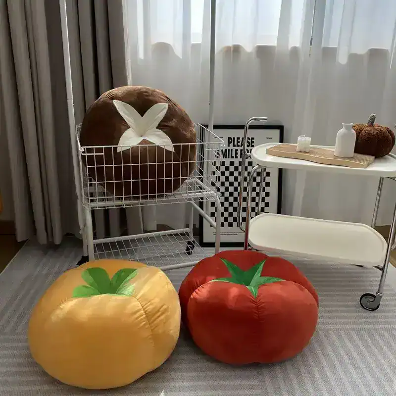 Plush tomato-shaped cushions with vibrant colors, perfect for home decor or kids' room accessories.