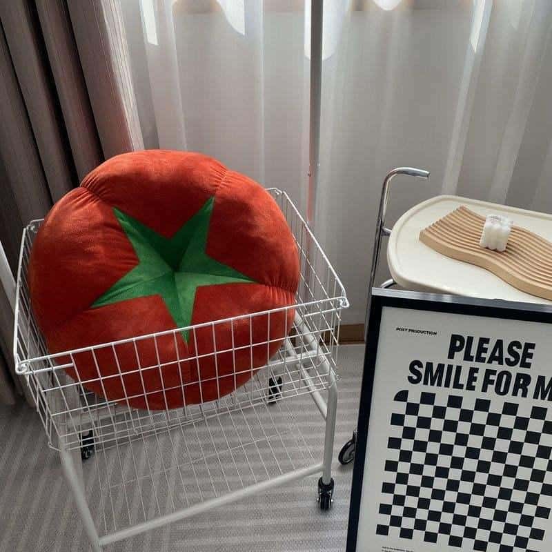 Soft plush tomato-shaped pillow in a shopping cart at Monalisa Store, emphasizing fun and comfort for eye care customers.