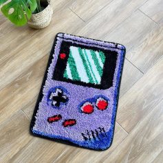Video game controller-shaped doormat with pixel art design, vibrant colors, and soft textured surface for home decor and entrance welcome mats.