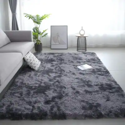 Luxurious gray shaggy area rug in modern living room with white sofa, decorative pillow, indoor plant, minimalist artwork, and side table with vase, perfect for cozy interiors.