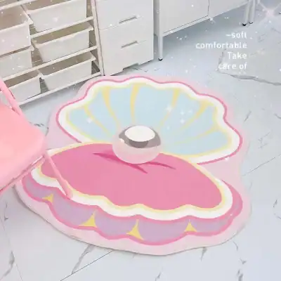 Bright pastel shell-shaped rug with soft, comfortable texture, ideal for children's rooms or cozy spaces, featuring a cute ball decoration, emphasizing gentle and soothing decor.