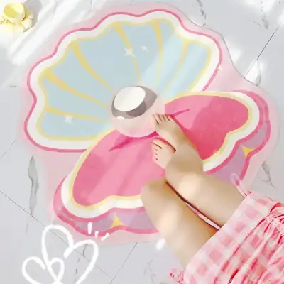 Soft pink butterfly-shaped rug with large eye design, kids feet on it, in bright room, playful nursery decor, comfortable and colorful, perfect for children's bedroom or playroom decor.