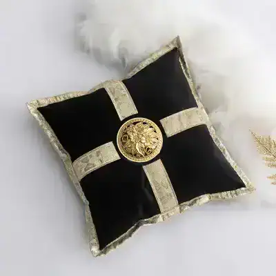 Luxurious black and gold decorative cushion with ornate medieval cross design and detailed embroidery, perfect for elegant home decor or special occasions.
