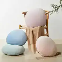 Plush round cushions and a cozy chair for comfortable reading or relaxing at Monalisa Store, offering stylish home decor accessories and designer pillows to enhance your living space.