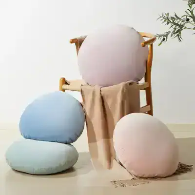 Plush round cushions and a cozy chair for comfortable reading or relaxing at Monalisa Store, offering stylish home decor accessories and designer pillows to enhance your living space.