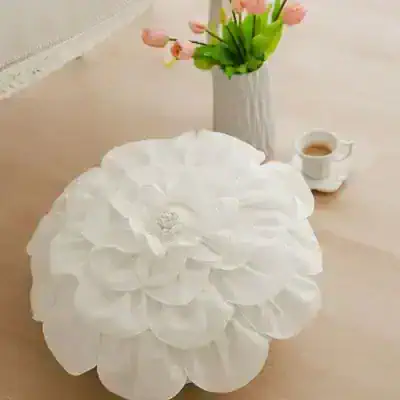 White flower-shaped tissue box cover for home decor and aesthetics.