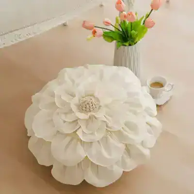 White flower-shaped ottoman with beige center for home decor and living room furniture.