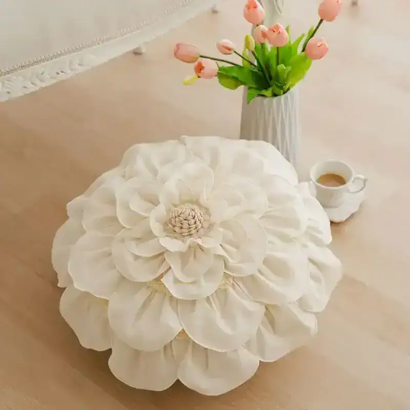 Flower-shaped decorative pillow, elegant white cushion with petal design, perfect for home decor or bedroom styling, soft and luxurious fabric, enhances aesthetic appeal of living space.