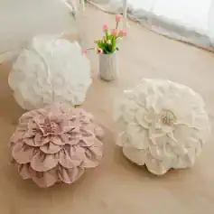 White decorative flower cushions with pink flower accents for home decor and floral accents for living spaces.