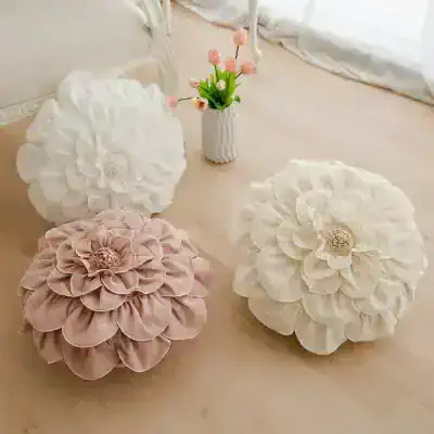 White decorative flower cushions with pink flower accents for home decor and floral accents for living spaces.