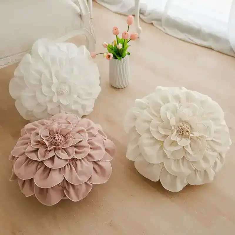 White decorative flower cushions with pink flower accents for home decor and floral accents for living spaces.