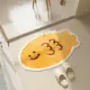 Smiley face emoji-shaped bathroom rug with slippers, cheerful and cozy home decor, inviting entrance, perfect for a welcoming atmosphere.