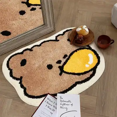 Cute Snoopy dog-shaped bath mat with a large yellow smiley face on a wooden floor. Perfect for adding playful decor to your bathroom or bedroom. Easy to clean and machine washable.