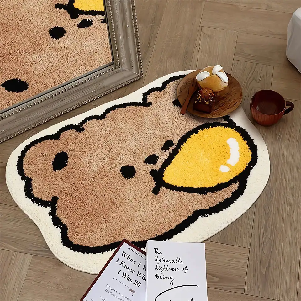 Cute Snoopy dog-shaped bath mat with a large yellow smiley face on a wooden floor. Perfect for adding playful decor to your bathroom or bedroom. Easy to clean and machine washable.