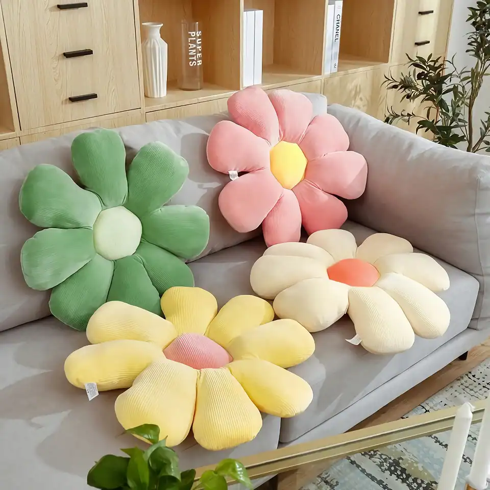 Bright floral-shaped plush cushions on a modern sofa, offering a colorful and cozy decor accent at Monalisa Store for home comfort and botanical-inspired interior design.