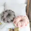 Luxurious plush knot throw pillows in soft grey and pink colors, perfect for modern bedroom decor and added comfort.