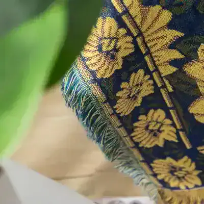 Vibrant embroidered textile with floral pattern and fringed edge, showcasing traditional craftsmanship and cultural design. Perfect for home decor or textile accessories.