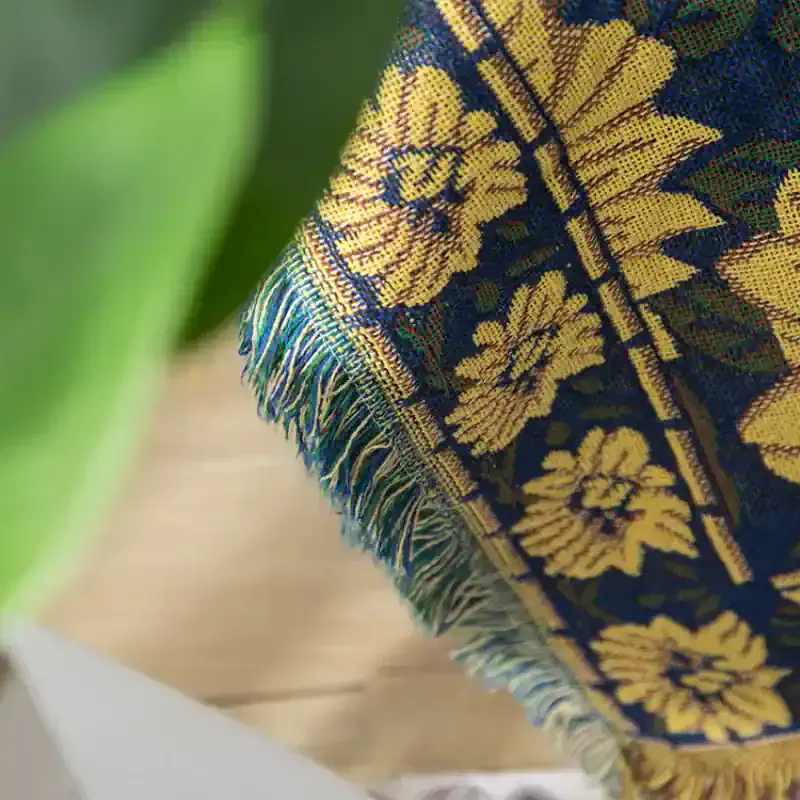 Vibrant embroidered textile with floral pattern and fringed edge, showcasing traditional craftsmanship and cultural design. Perfect for home decor or textile accessories.