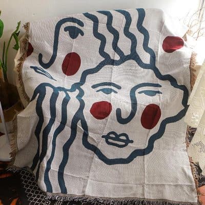 Vibrant monochrome abstract face blanket with red accents, ideal for home decor and cozy living rooms, inspired by modern art for stylish interior design.