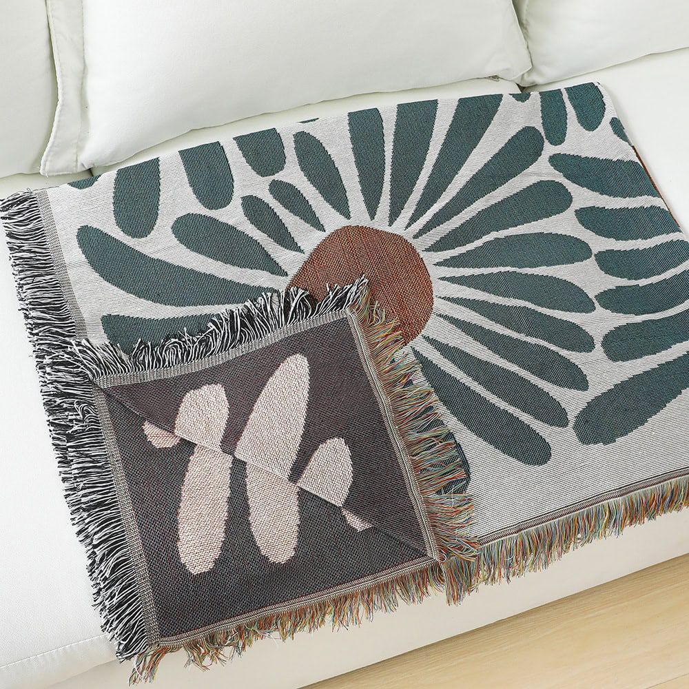 Vibrant floral patterned throw blanket on a white couch, enhances home decor with colorful, sunburst and butterfly motifs, perfect for cozy living room accents.