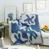 Silk throw blanket with abstract blue and white design on a white sofa, modern living room decor, Monalisa Store decorative cozy home accents, stylish and elegant home accessories, luxury interior style.