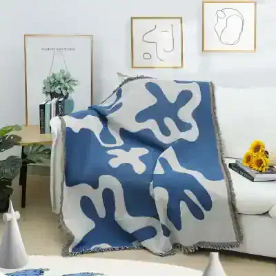 Silk throw blanket with abstract blue and white design on a white sofa, modern living room decor, Monalisa Store decorative cozy home accents, stylish and elegant home accessories, luxury interior style.