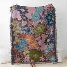 Colorful floral embroidered throw blanket displayed on a white background for home decor or bedroom accent.