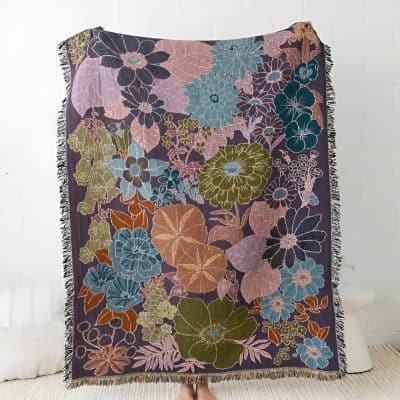 Colorful floral embroidered throw blanket displayed on a white background for home decor or bedroom accent.