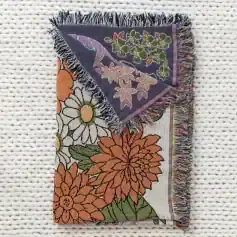 Vibrant floral tapestry featuring colorful embroidered flowers, with fringed edges, perfect for home decor or as a gift at Monalisa Medical Store.