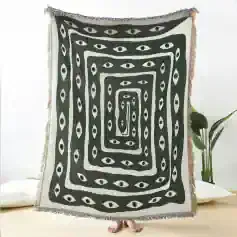 Bright monochrome throw blanket with eye motif, perfect for modern bedroom decor and adding a stylish touch to your living space.